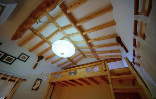 a room with a ceiling with wooden beams and a door at Jungdam in Jeonju