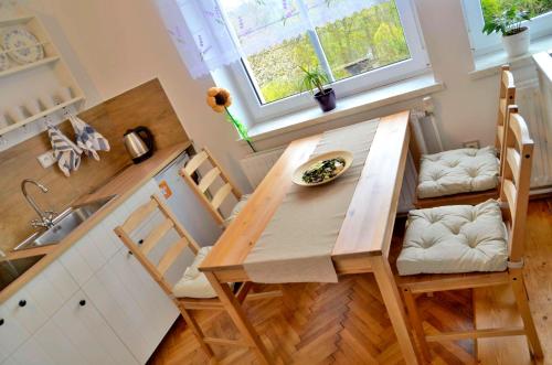 a dining room table and chairs in a kitchen at Vila Kateřina in Broumov