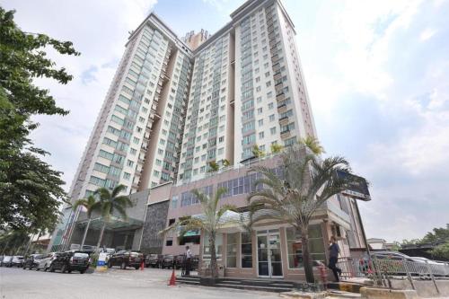 a large building with palm trees in front of it at The BCC Hotel & Residence in Nagoya