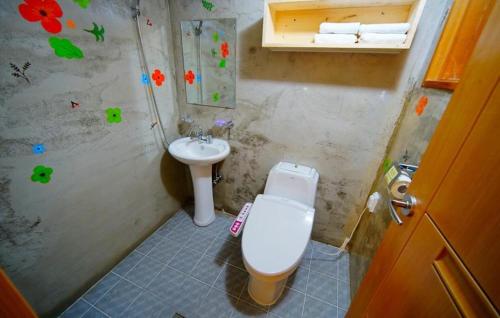 a bathroom with a toilet and a sink at Jungdam in Jeonju