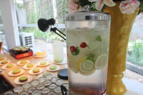 a blender with fruit in it sitting on a table at Pomelotel Patra Kuningan Jakarta in Jakarta