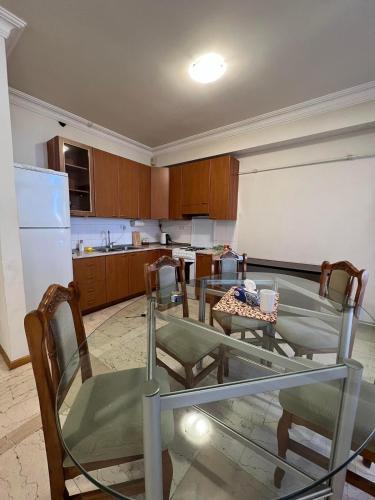 a kitchen with a table and chairs and a refrigerator at Perfect Grin Point with fire-place in Aghk'ilisa