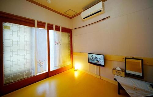 a room with a window and a television in it at Jungdam in Jeonju