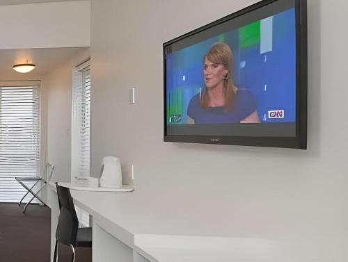 a flat screen tv hanging on a wall at The Riccarton Hotel in Christchurch