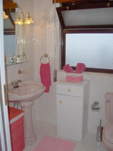 a bathroom with a sink and a toilet at Casa do Costa in Fajã