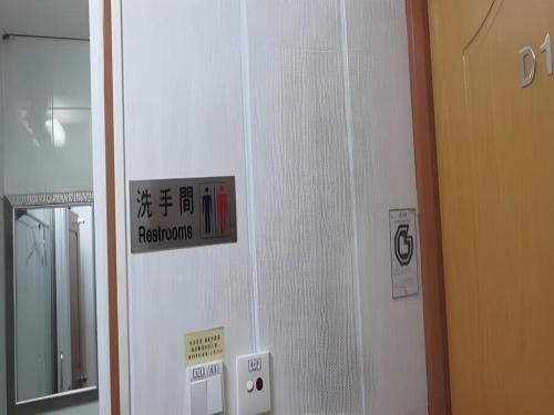a sign on the wall of a hospital room at New Mong Kok Guest House in Hong Kong