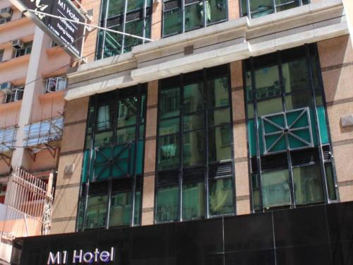 a building with glass windows on the side of it at M1 North Point Hotel in Hong Kong