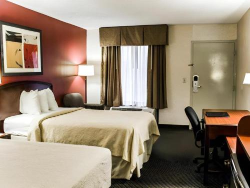 a hotel room with two beds and a desk at Roanoke near Lake Gaston in Weldon