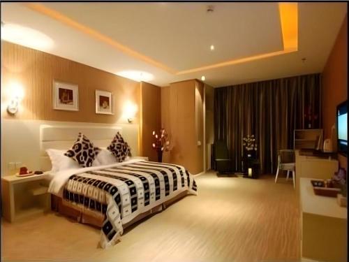 a hotel room with a bed and a television at Chengdu Huadu Times Hotel in Chengdu