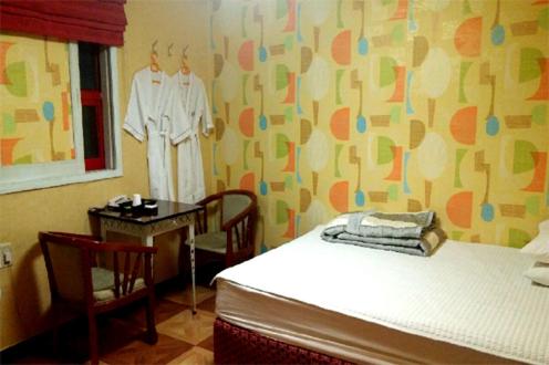 Ένα ή περισσότερα κρεβάτια σε δωμάτιο στο J Motel Gwangalli Busan