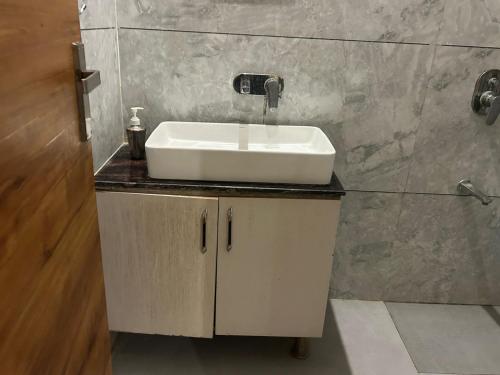 a bathroom with a white sink and a shower at Hotel Moon Regency I Couple and Corporate Friendly I Panipat in Pānīpat