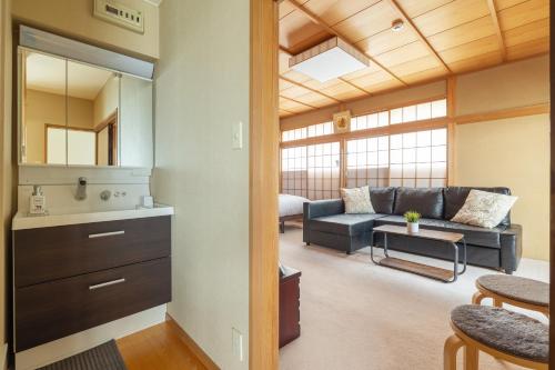 a living room with a couch and a table at The Ivy Apartments, BEST Location, Yoyogi!! in Tokyo