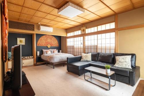 a living room with a couch and a bed at The Ivy Apartments, BEST Location, Yoyogi!! in Tokyo