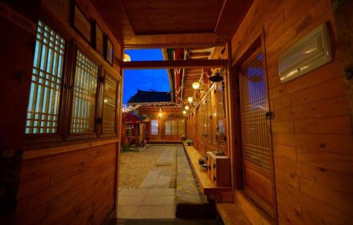 an empty hallway of a wooden house with a pathway at Jungdam in Jeonju