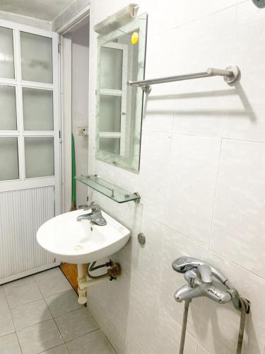 a bathroom with a sink and a mirror at HouseTQV3 in Hanoi
