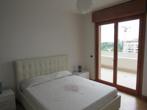 a bedroom with a bed and a sliding glass door at Pianeta Roma 45 in Rome