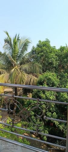 a view of a palm tree from a fence at Hotel Aishwarya New Digha I Near Amrabati Park in Digha