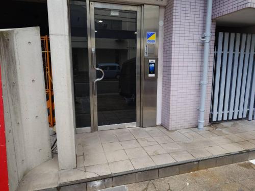 an entrance to a building with a revolving door at N's Hotel 平和公園 in Hiroshima
