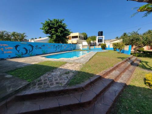 a swimming pool in the backyard of a house at Bel Canto Lodge in Fombeni
