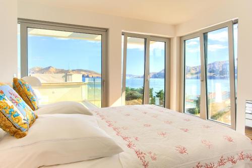 a bedroom with a bed with a view of the ocean at The Oscar in Baška