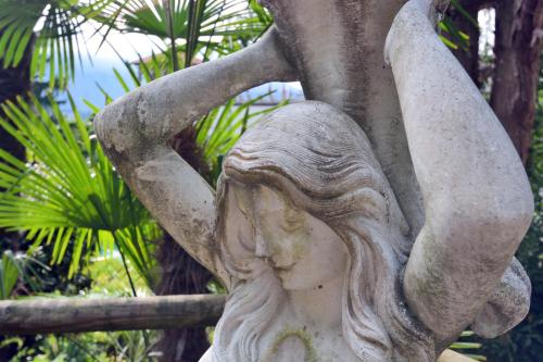 a statue of a woman with her arms in the air at Grand Hotel Cadenabbia in Griante Cadenabbia