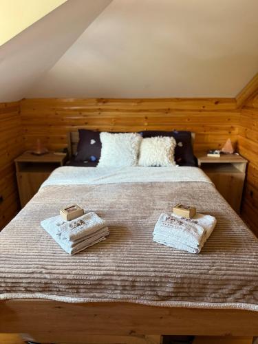 a bedroom with a bed with two towels on it at Vila Rudnicka Idila in Gornji Milanovac