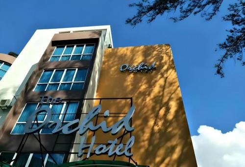 a building with a sign on the side of it at The Orchid Hotel in Sibu