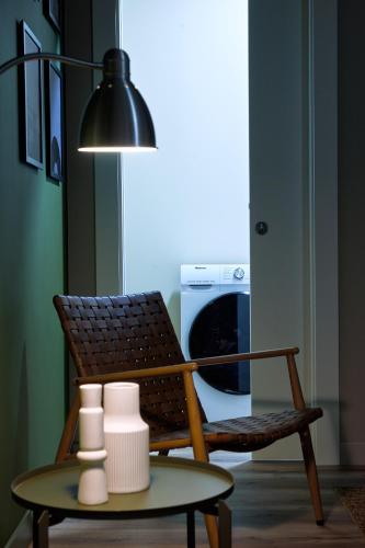 a living room with a chair and a table with vases at The School Venice, boutique Loft in Venice
