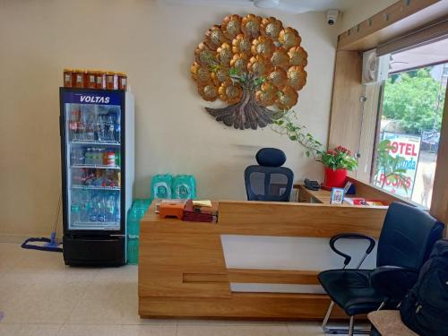 a soda machine in a room with a drink cooler at Hotel Mukund and Restaurant in Nāthdwāra