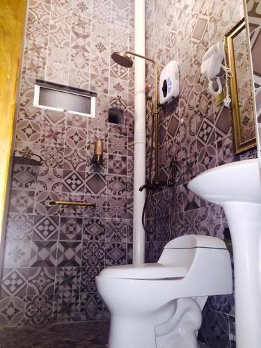 a bathroom with a toilet and a sink at Kampong Pinang Sebatang Melaka in Melaka