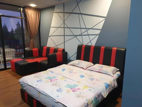 a bedroom with a bed and a chair at Happy Village Kundasang in Ranau