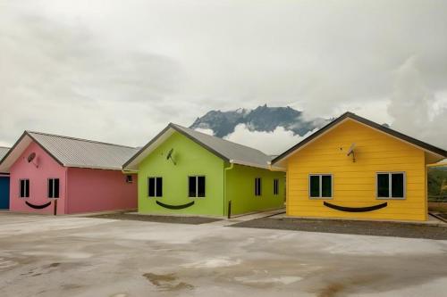 a row of houses with smiles painted on them at Happy Village Kundasang in Ranau