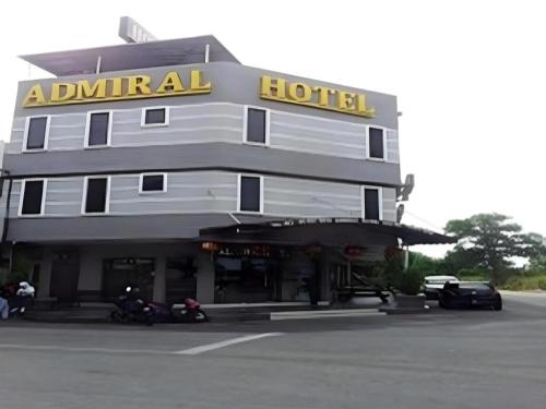 a hotel with motorcycles parked in front of it at Admiral Hotel in Sitiawan