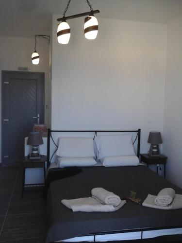 a bedroom with a bed with two towels on it at Grande Murano in Fira