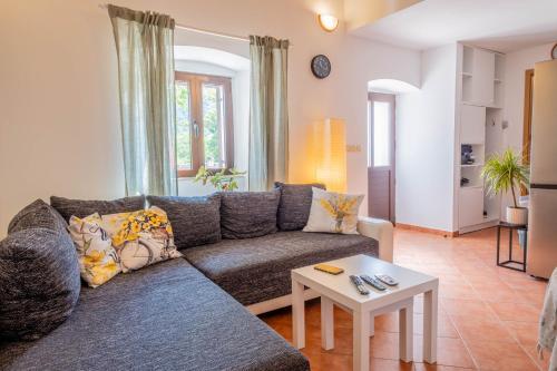 a living room with a couch and a table at Apartman Stefani in Drivenik
