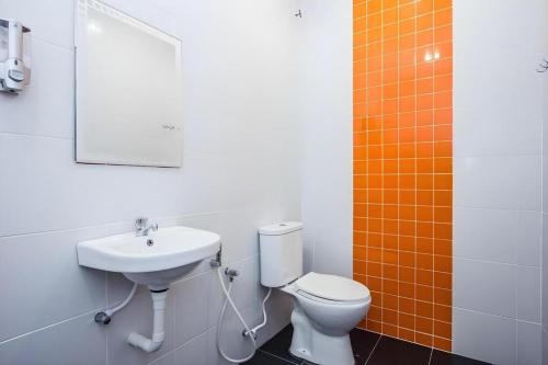 a bathroom with a toilet and a sink at Big Orange Hotel Jitra in Alor Setar