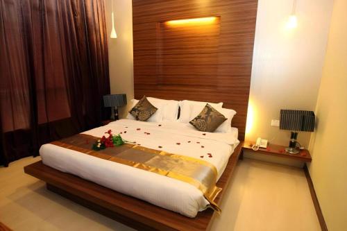 a bedroom with a large white bed with decorations on it at Uptown Imperial Kajang in Kuala Lumpur