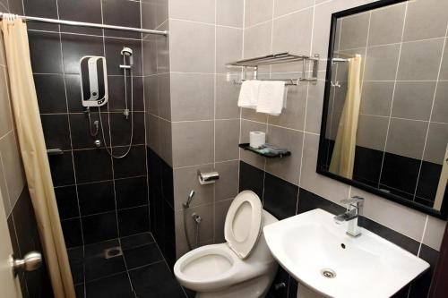 a bathroom with a toilet and a sink at Uptown Imperial Kajang in Kuala Lumpur