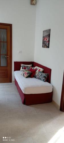 a bed with pillows on it in a room at La casota 'd Marmo in Castagnole Lanze