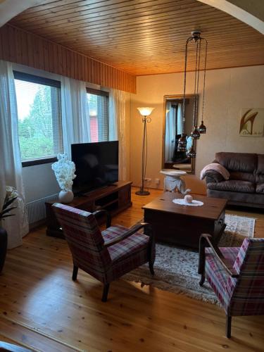 a living room with a couch and a table at Villa MarBet in Kauhava