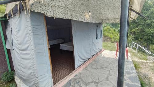 an inside of a tent with a bed in it at Nature Height Camps & Cottages Pangot in Nainital