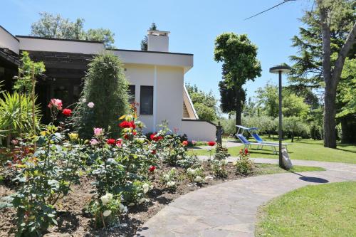 a garden with flowers in front of a house at Al Villino del Sole in Fano