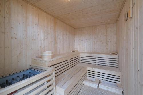 a sauna with wooden walls and a wooden floor at Aster Apartment Bali in Canggu