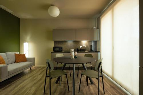 a living room with a table and chairs and a couch at The School Venice, boutique Loft in Venice