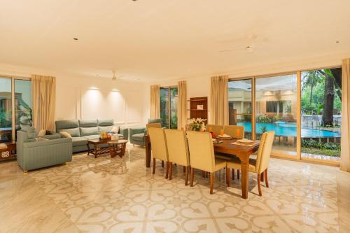 a large living room with a table and chairs at 5-BHK Villa With Common Pool & Lift Near Beaches in Majorda