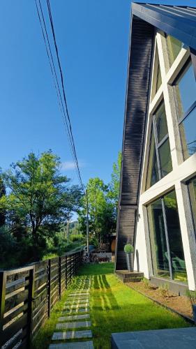 a house with a fence next to a yard at Gloriosa Chalet in Voronet