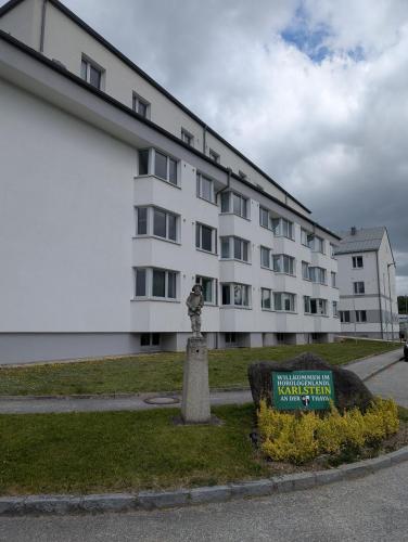 a large white building with a sign in front of it at Schülerwohnheim Karlstein in Karlstein