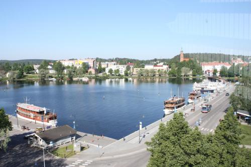 a view of a river with boats in the water at Summer Hotel Tott in Savonlinna