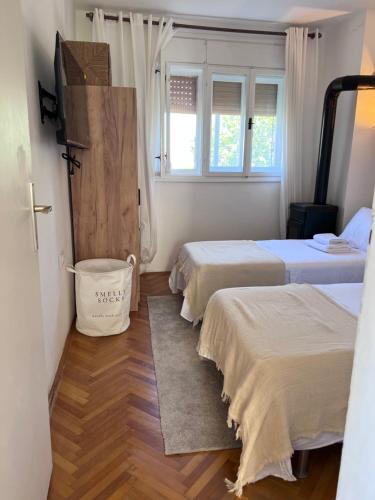a room with two beds and a bucket in it at Villa Mandarin in Opuzen