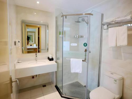 a bathroom with a shower and a sink and a toilet at GreenTree Inn Chaohu High Speed Rail East Station in Chaohu